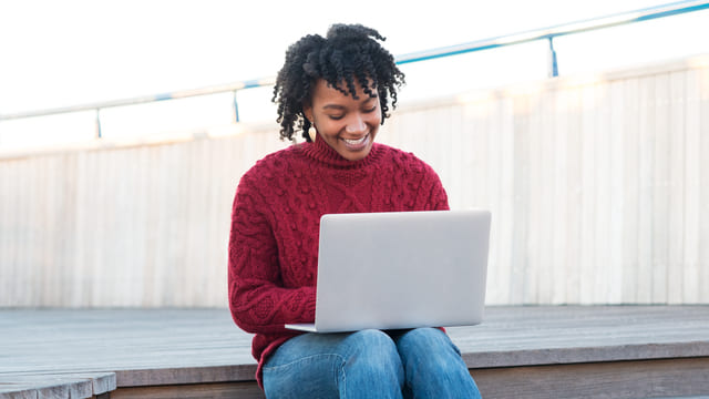 Finance and accounting apprentice researching employers on laptop