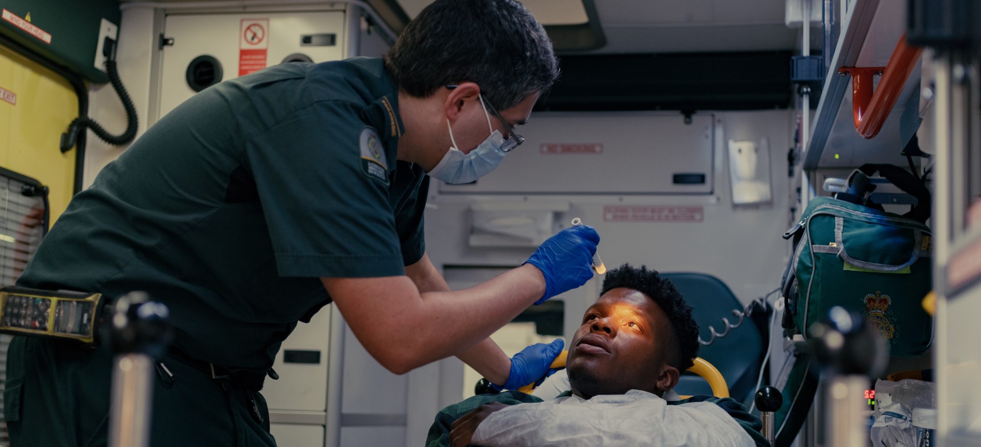 Paramedic treating patient in an ambulance