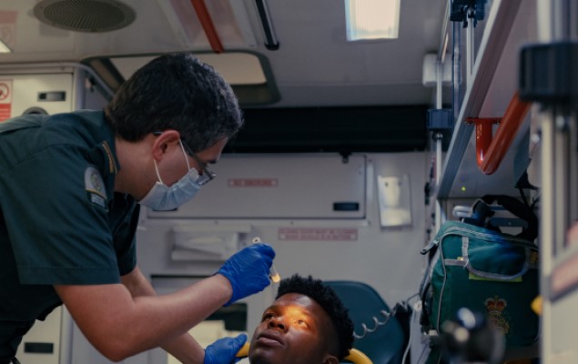 Paramedic treating patient in an ambulance