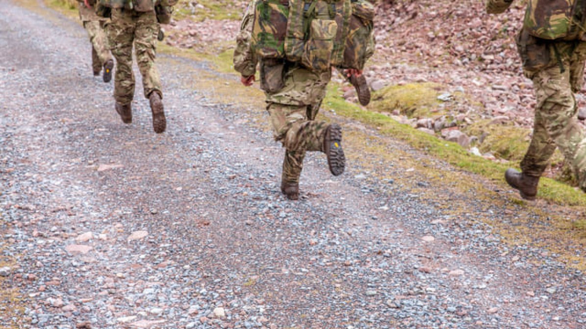 Soldiers legs running along track 